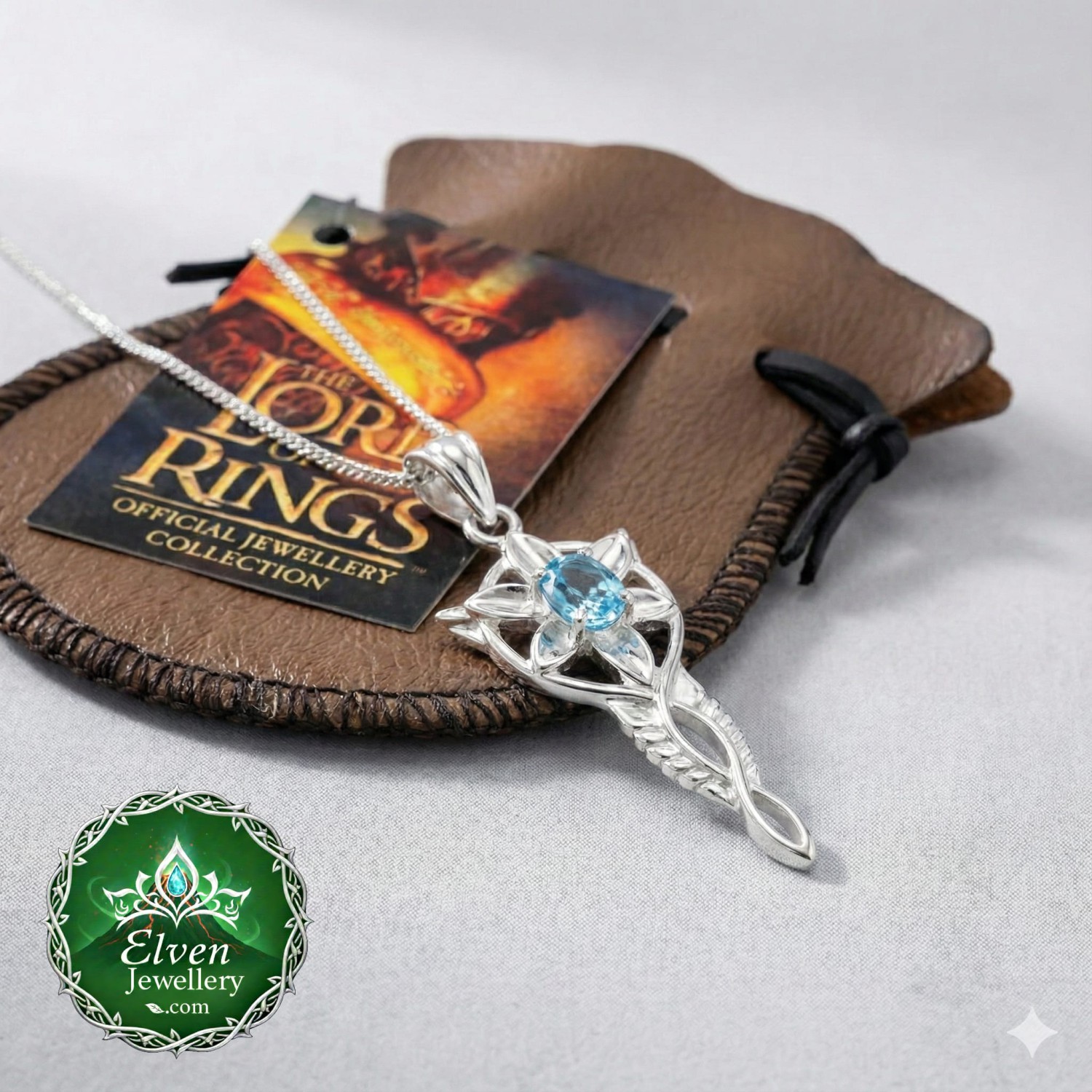 Official Arwen Evenstar Miniature Blue Topaz Pendant — Sterling Silver & Genuine Blue Topaz — lotrjewelry.com Official miniature Arwen Evenstar pendant necklace in solid 925 sterling silver with genuine natural blue topaz centre stone and cubic zirconia star points, claw-set, 35mm, Mohs 8, New Line Productions licensed Lord of the Rings jewellery