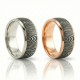 The Strata Wedding Ring: A polished yellow gold band featuring a central inlay of laser-carved black zirconium with a wavy woodgrain pattern, standing on a white background.