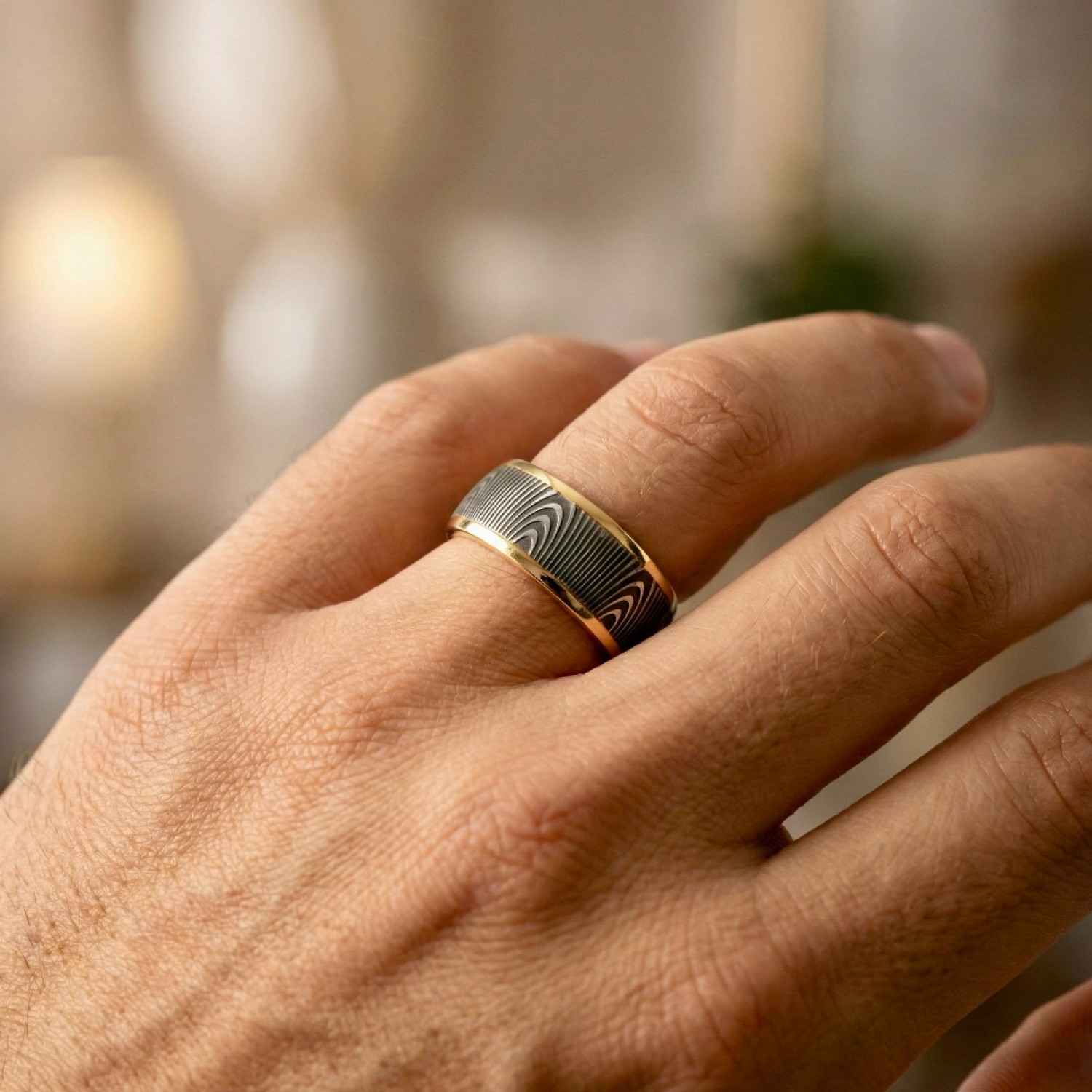 The Strata Wedding Ring: A polished yellow gold band featuring a central inlay of laser-carved black zirconium with a wavy woodgrain pattern, standing on a white background.