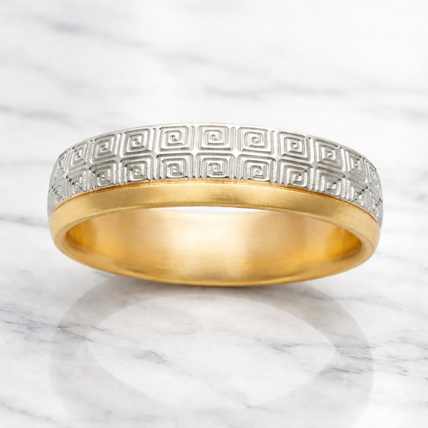 Two-tone gold wedding band featuring a continuous white gold Greek Key pattern with polished yellow gold rails.