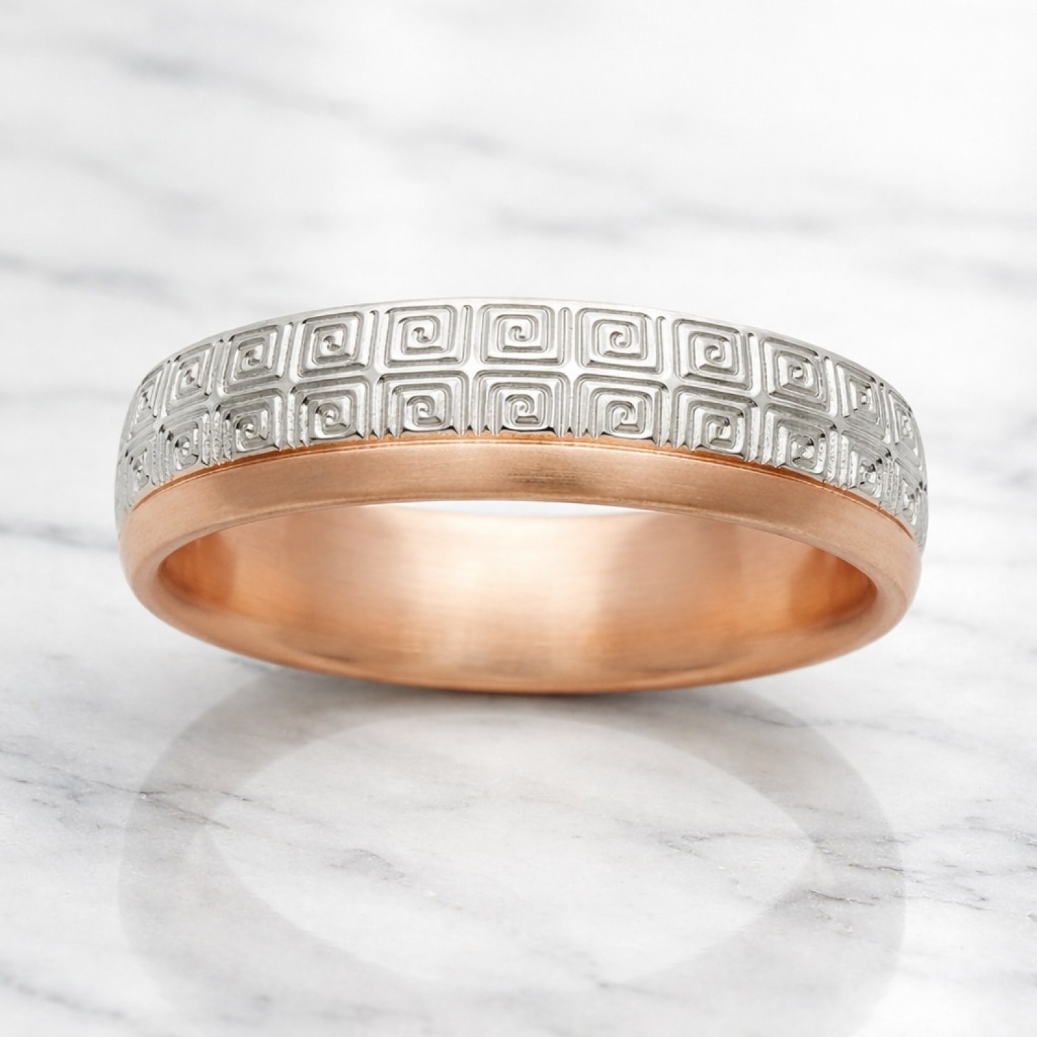 Two-tone gold wedding band featuring a continuous white gold Greek Key pattern with polished yellow gold rails.